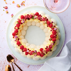 Decorative dessert with raspberries on a light blue plate
