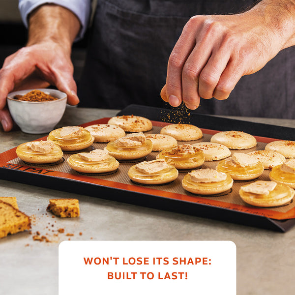 Cook N' Cool Perfect Baking Tray And SILPAT Baking Mat with Human Hands Sprinkling Cinnamon On Macarons