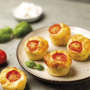Freshly baked muffins in Silpat Perfect Muffin Mold cooling on rack