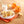 Halloween-themed cookies on a plate with milk and pumpkins in the background.